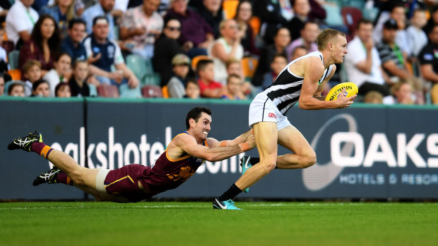 One on one: Brisbane's Darcy Gardiner tackles Jaidyn Stephenson of Collingwood at the Gabba.