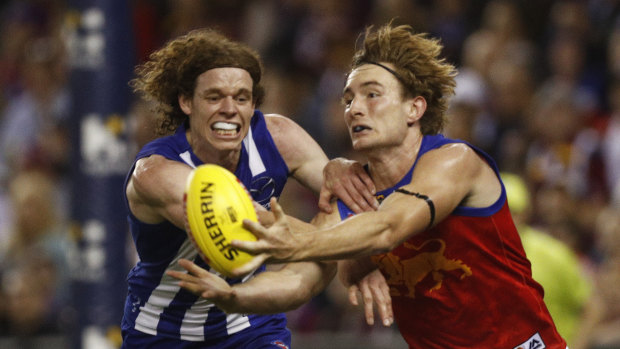 Harris Andrews of the Brisbane Lions competing with North's  Ben Brown.