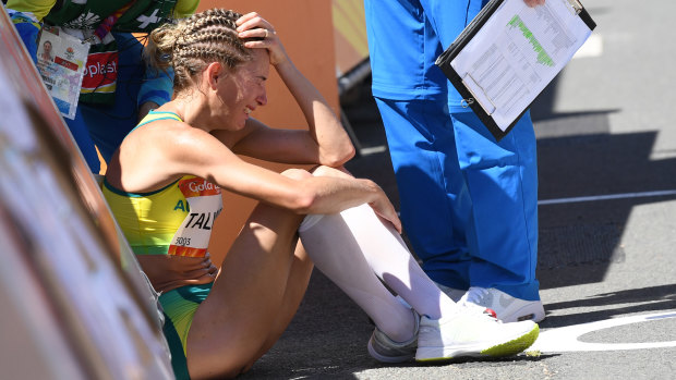 Heartbroken: A race official talks to Claire Tallent of Australia after she was disqualified during the 20km race walk.