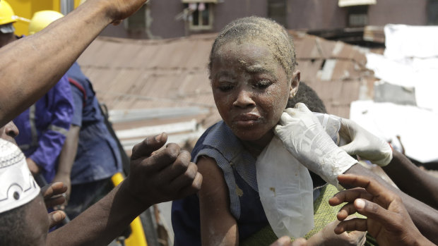 A child is rescued from the rubble of a collapsed building in Lagos, Nigeria.