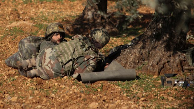 Turkish-backed rebel fighters take positions near the village of Neirab in Idlib province last week.