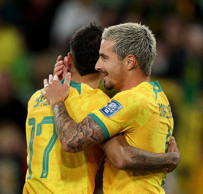 Jamie Maclaren of the Socceroos celebrates a goal with teammate Keanu Baccus of the Socceroos.
