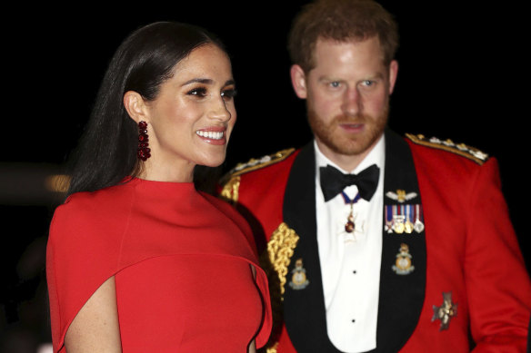 Prince Harry and Meghan, Duchess of Sussex arrive at the Royal Albert Hall in London in March. A new book promises to revisit the moments leading up to their "divorce" from the royal family.