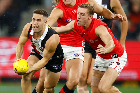 Jade Gresham of the Saints is tackled by Will Setterfield of the Bombers.