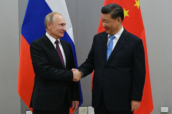 Russian President Vladimir Putin, left, with China’s Xi Jinping. 
