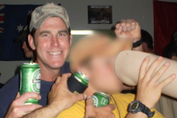 Ben Roberts-Smith (left) with a then-colleague drinking from the prosthetic leg of a dead Afghan man in 2012.