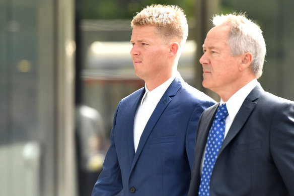 Sam Walker arrives at the County Court on Wednesday with his father, Tim Walker, QC.