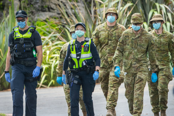 Australian Defence Force personnel and Victoria Police in Fitzroy Gardens in Melbourne.
