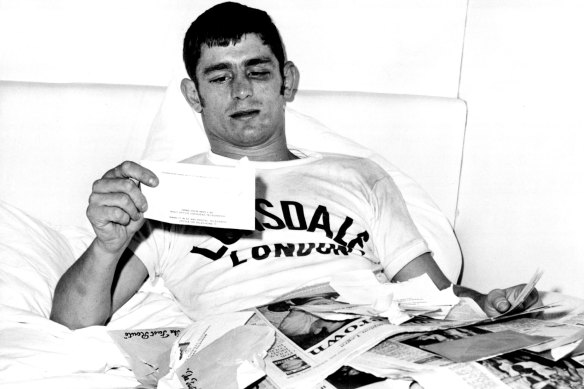 Famechon reads his reviews at London’s Cumberland Hotel the morning after his 1969 featherweight title triumph.