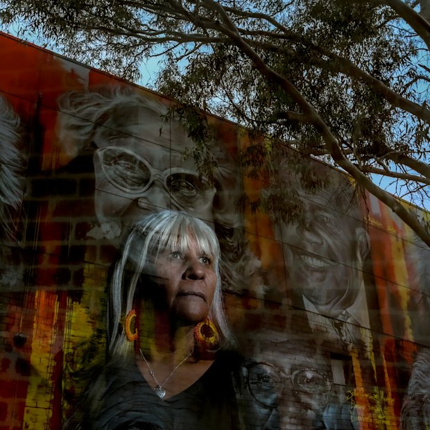Aunty Eva-Jo Edwards stands in front of a mural depicting elders on the Aborigines Advancement League building in Thornbury. She says a treaty would benefit all Victorians.