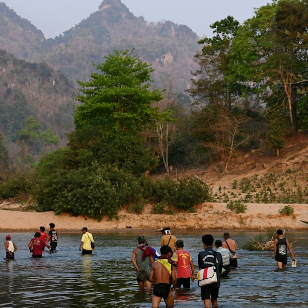 A group of men from Pu Lu Palaw village cross the Moei River back into Myanmar, on the border with Thailand. 