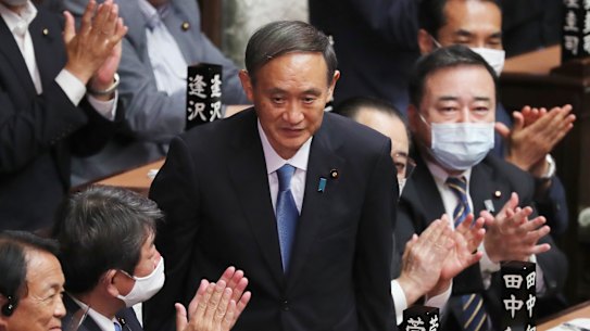 Yoshihide Suga is applauded after being elected as Japan's new Prime Minister in Parliament on Wednesday.