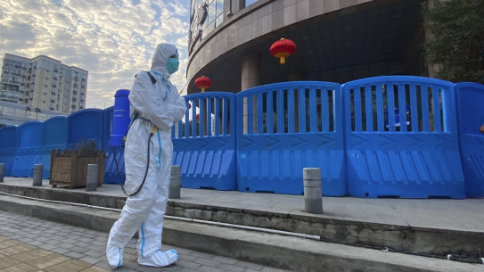 A worker with disinfecting equipment outside Wuhan Central Hospital in February.