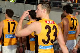 Jack Ginnivan of the Hawks gives a finger to Crows fans as the Hawks walk off in defeat.