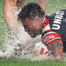 Wet and wild: Spencer Leniu scores for the Roosters againt Parramatta on Friday.