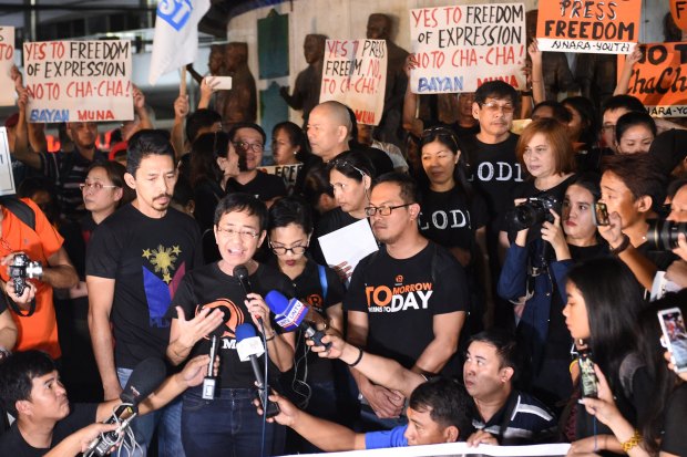  Ressa (holding a microphone) and fellow journalists campaigning for press freedom. Since 2018, Ressa, Rappler and its staff have faced 13 government investigations.