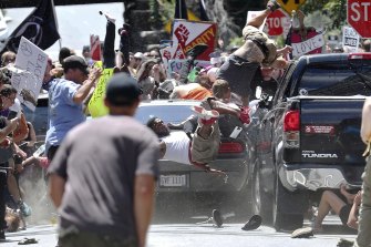 A vehicle drives into a group of protesters demonstrating against a white nationalist rally in Charlottesville, Virginia in 2017. 