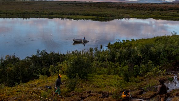 Frederic Thalasso takes gas samples from the lake via boat. 
