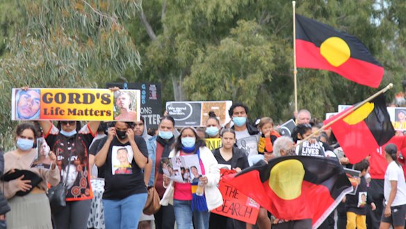 Crowds walk through the streets of Moree in July, nearly three weeks after Gordon vanished.