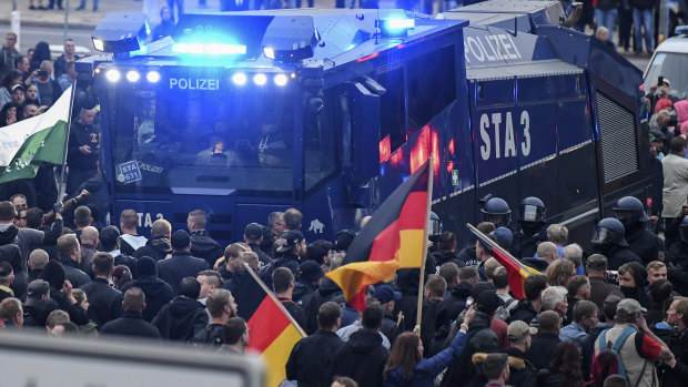 A police water cannon stands between far-right demonstrators in Chemnitz, eastern Germany, last week.