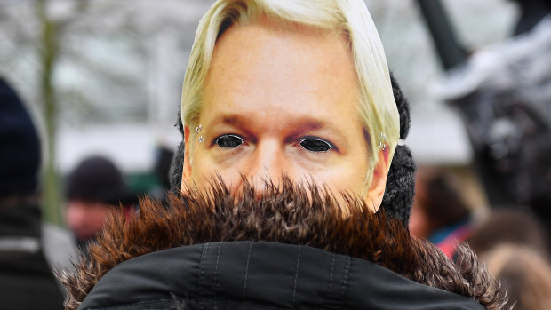 A protester wears a mask of Julian Assange's face outside Belmarsh prison prior to the extradition hearing of WikiLeaks founder Julian Assange.