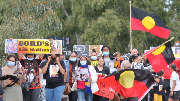 Crowds walk through the streets of Moree in July, nearly three weeks after Gordon vanished.