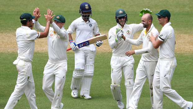 Man of the moment: Nathan Lyon takes his fifth wicket in India's second innings.