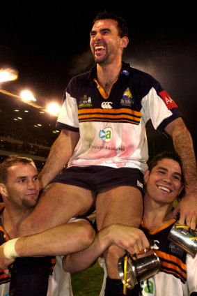 Joe Roff, centre, and team mates Peter Ryan and Jeremy Paul celebrate the Brumbies' Super 12 win in 2001. 