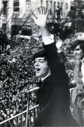 The Beatles wave to the fans from the first-floor balcony of the Southern Cross Hotel in Melbourne.