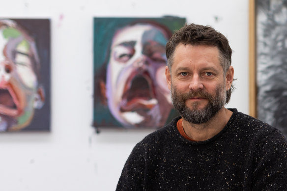 Ben Quilty in his studio with his <i>Sonny</i> series.