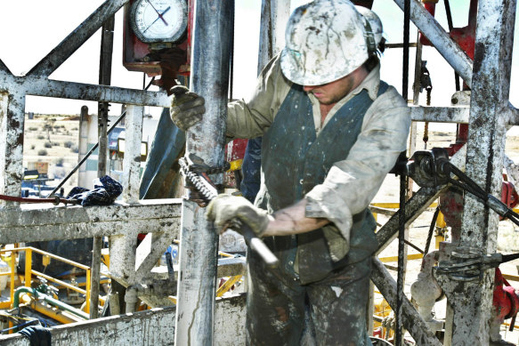 A worker repairs drilling pipes on a site in the Cooper Basin region in South Australia.