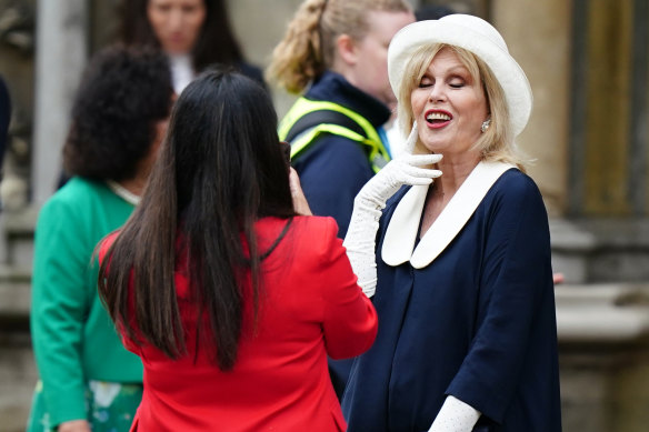 Dame Joanna Lumley poses for a photograph as she arrives at Westminster Abbey.