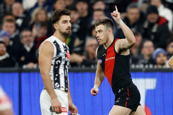 Merrett celebrates a goal while Josh Daicos watches on.