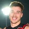 Angus Clarke of the Bombers celebrates his first game and win with Zach Merrett.