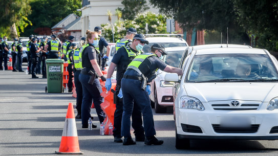 Police stop motorists travelling from NSW at a checkpoint in Wodonga on the Victorian side of the border.