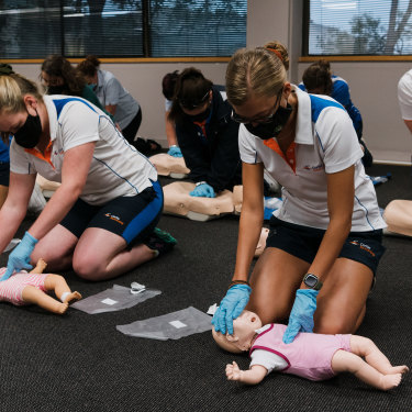 Students practise CPR for children (front) and adults (back) on “Annie” dummies during a class at Carlile Swimming in Lane Cove West. 