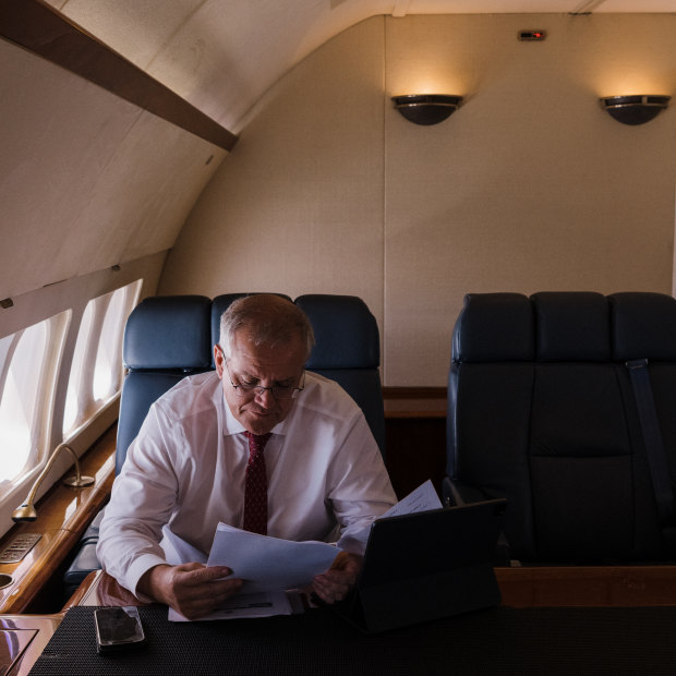 Work to be done: Morrison on board a RAAF Boeing 737 from Sydney to Brisbane.