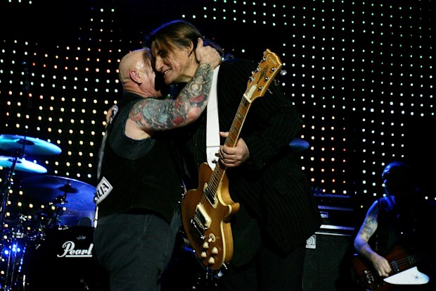 Mick Cocks (right) joins bandmate Angry Anderson (left) of Rose Tattoo on stage briefly during the One For The Boys - Mick Cocks Benefit at the Enmore Theatre on July 24, 2009 in Sydney
