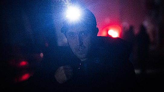 A man has to use his own illumination after Kiev’s city centre lost electrical power in Thursday’s Russian rocket attack.