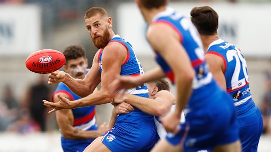 Liam Jones handballs for the  Bulldogs during a practice match against North Melbourne.