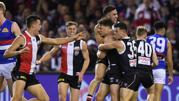 Sparkling debut: Doulton Langlands (fourth from right) celebrates his first goal for St Kilda during their win over Melbourne at Marvel Stadium in Melbourne.