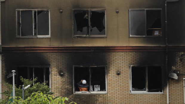 An investigator takes pictures inside the Kyoto Animation Studio building on Friday.