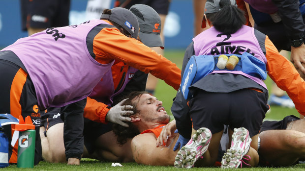 Knocked out: Giants captain Phil Davis receives medical attention before being helped from the field at Spotless Stadium.