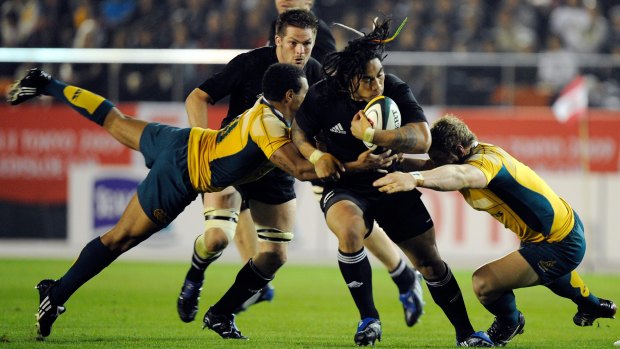 Debutant: Will Genia, left tackling Ma'a Nonu, first turned out for the Wallabies against the All Blacks in 2009.