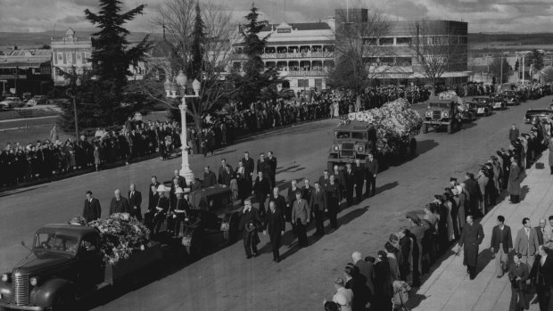 Funeral procession of former Prime Minister, Joseph Benedict Chifley, moves slowly along Russell St 
on the way to Bathurst cemetery, while people stand in silent tribute. June 17, 1951.