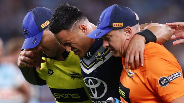 Valentine Holmes leaves the field in agony on Friday night.