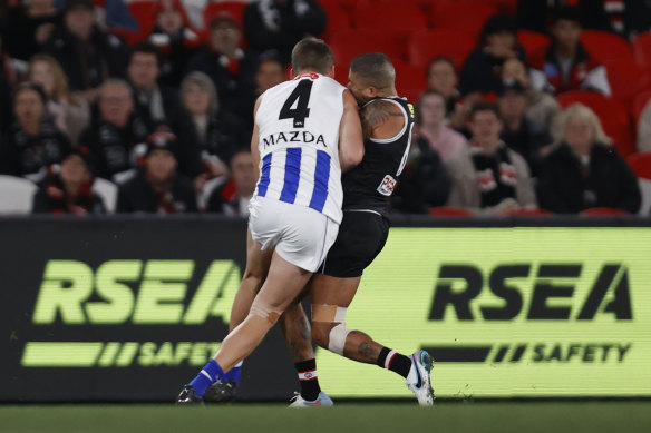 Aidan Corr of the Kangaroos flattens Bradley Hill of the Saints.