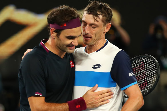John Millman, right, congratulates Roger Federer after their third-round showdown at the Australian Open.