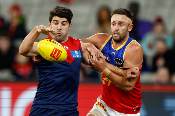 Jack Gunston, right, tackles Christian Petracca of the Demons. An MCL strain has left Gunston in a race against the clock to be fit for finals.