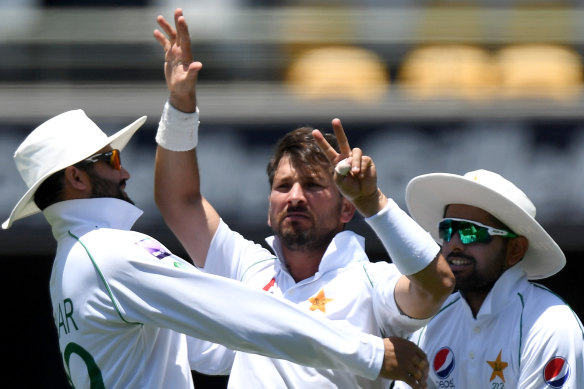 Count them:  Yasir Shah, centre, gives Steve Smith a pointed send-off at the Gabba. 